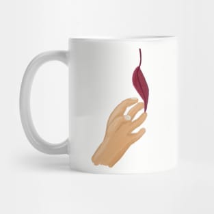 Hand reaching for the last leaf Mug